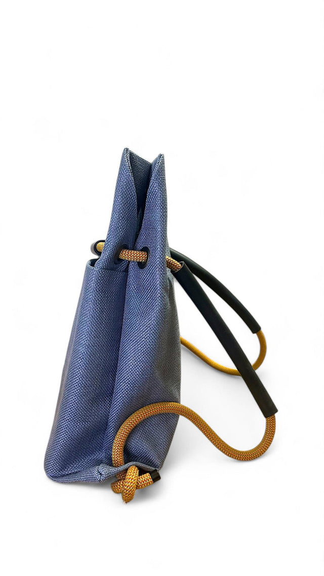 Side view of blue textile convertible bag with recycled climbing rope handle