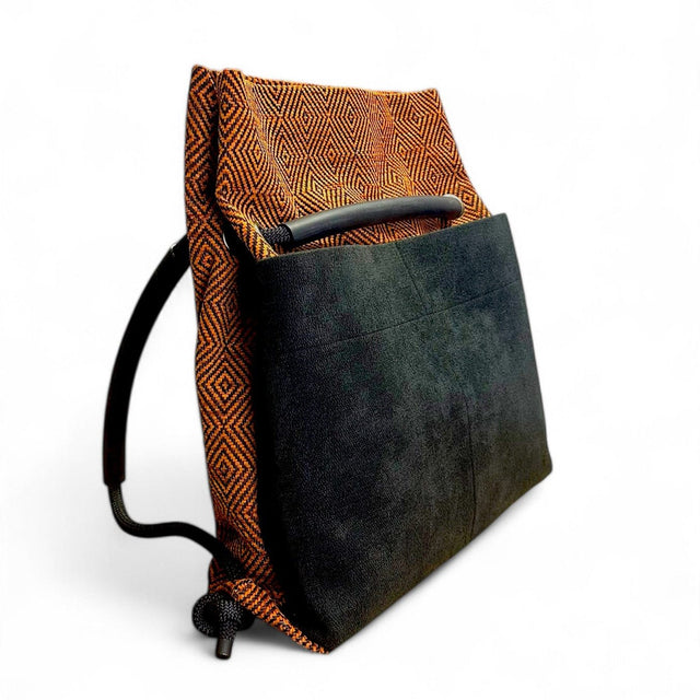 orange & black geometric convertible Ditto backpack with black pockets.