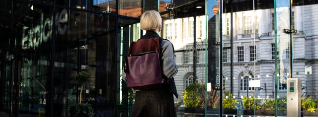plum ditto backpack modelled in modern glass architecture