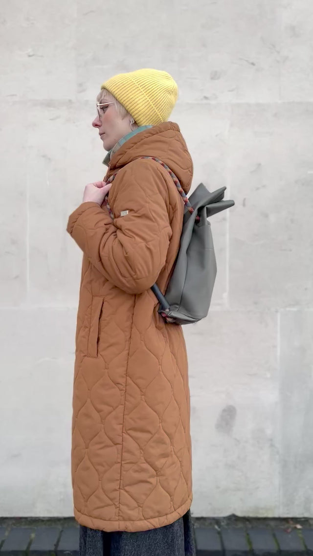 Olive-grey faux pleather convertible bag going from back to shoulder