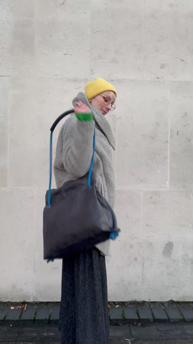 black distressed faux pleather convertible bag going from shoulder to back