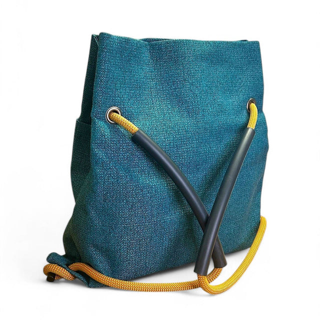 Back view of teal textile convertible backpack with recycled climbing rope handle