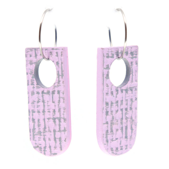 Pair of pink earrings with a subtle grey texture pattern on a white background