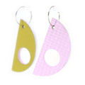 reversible earrings, one in moss green and the other pink, on a white background