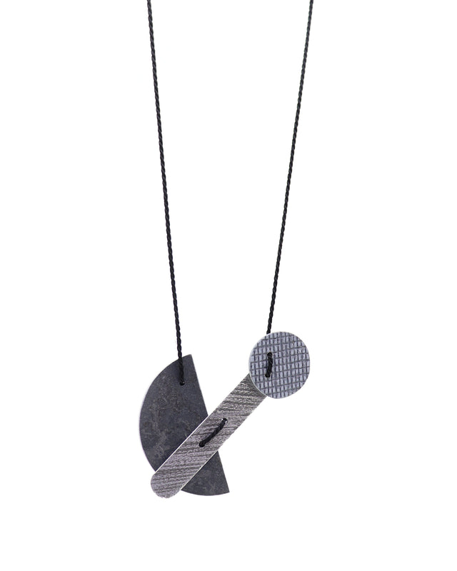 Necklace with bauhaus modernist pendant on a white background